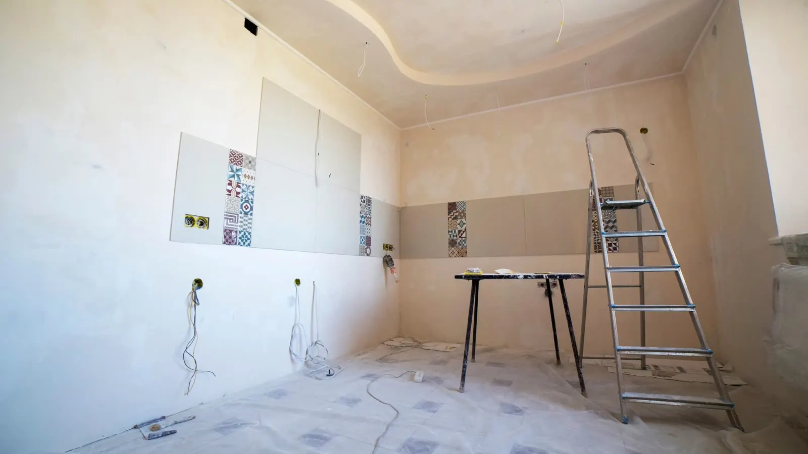 A room stripped back to the substrate with the floor sheeted over